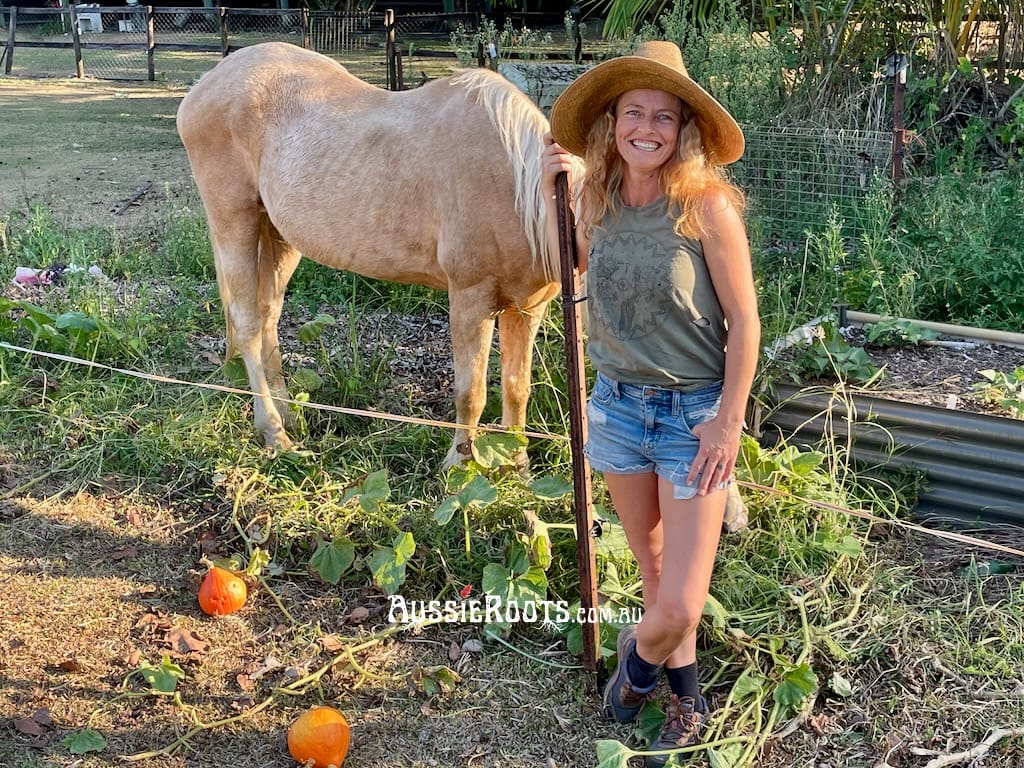 Elle from Aussie Roots in the vegetable garden with Athena the horse